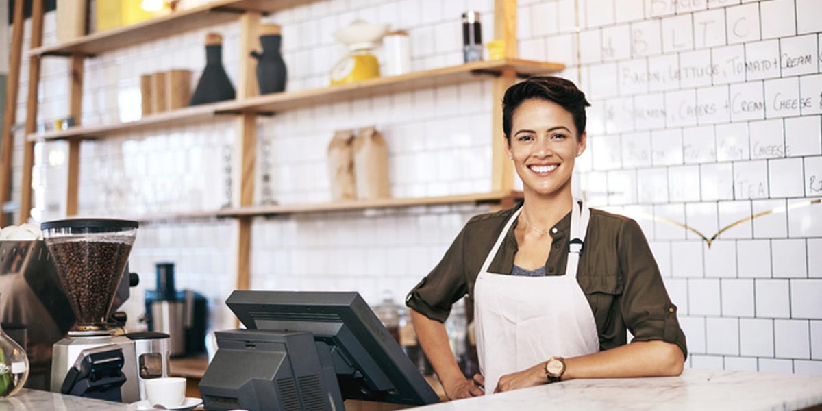 woman smiling at restaurant cash register