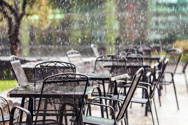 Rain falling on restaurant tables